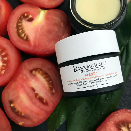 A glass container of Rawceuticals™ Blend™ Moisturiser with tomatoes and leaves on the background, uploaded on Spa Circle Brands product listing page.