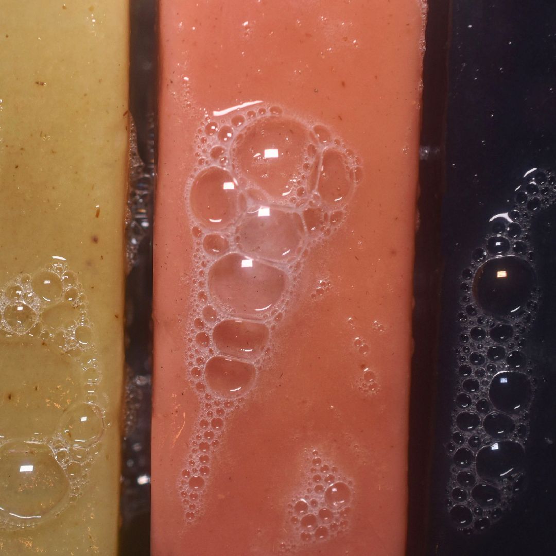Load image into Gallery viewer, Yellow, orange, and black Rawceuticals Raw Body Bar with soap bubbles, on Spa Circle Brands product listing page.
